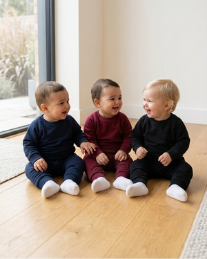 All three babies laughing and looking at each other