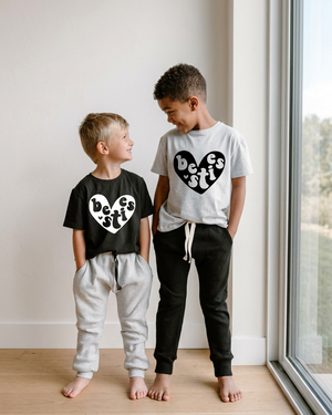 Boys in coordinating besties shirts in a modern home interior with a window and no outlet
