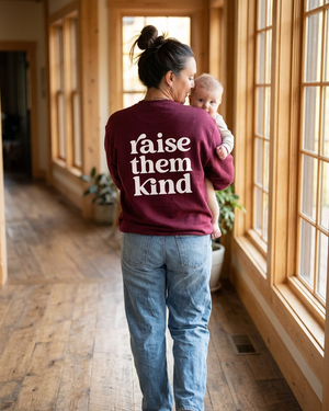 Burgundy Raise Them Kind walking with baby