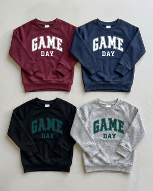 Four GAME DAY crewnecks with green and white prints