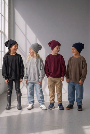 Four kids in lounge sweaters, with the far-right boy’s sweater changed from navy to brown