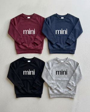 Four mini crewnecks, white lettering on dark colours and black on heather grey
