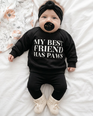 Full-body baby photo with black headband and leggings