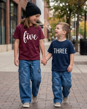 Girl’s burgundy shirt with white cursive five and boy’s navy shirt with white block THREE
