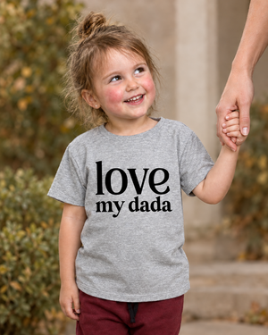 Girl wearing a tee with a larger love my dada print