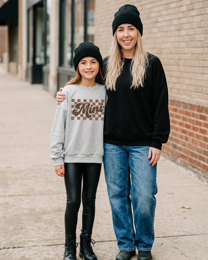Mother and daughter wearing the Mini Check crewneck and black lounge sweater