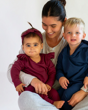 Mother with the boy in navy and the girl in burgundy with a matching headband