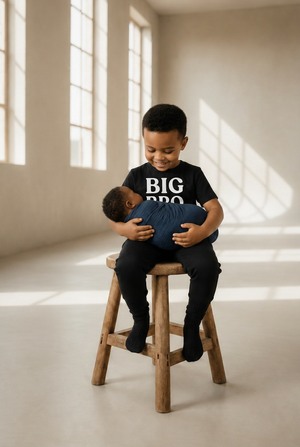 Older brother holding baby with stacked BIG BRO lettering