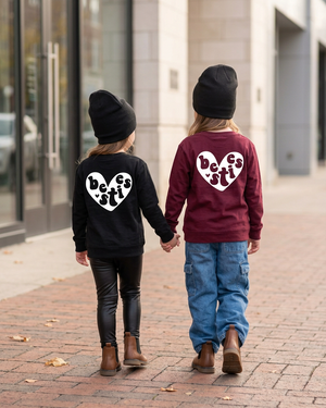 Sisters walking away holding hands