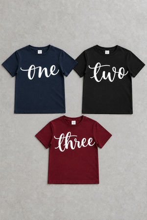 Three script birthday tees on concrete with corrected three lettering