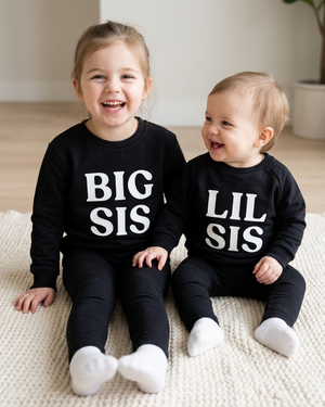 Three-year-old BIG SIS and one-year-old LIL SIS in crewnecks
