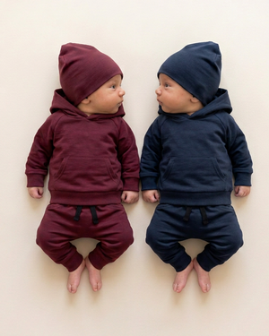 Two babies in burgundy and navy pullover hoodies with front kangaroo pockets
