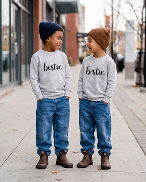 Two boys wearing grey sweaters with black bestie lettering and no chest pockets