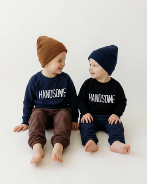 Two little boys in HANDSOME sweaters, beanies, and relaxed sweatpants